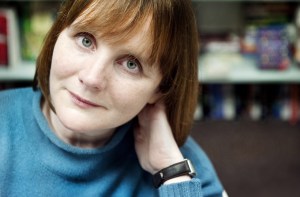 Sarah Hilary portrait and collects of her grandparents and mother that were taken in a Japanese POW camp. Mementos - a heart shaped pendant and a crucifix carved from the canopy of a plane and a book.  Photo by Linda Nylind. 31/1/2014.